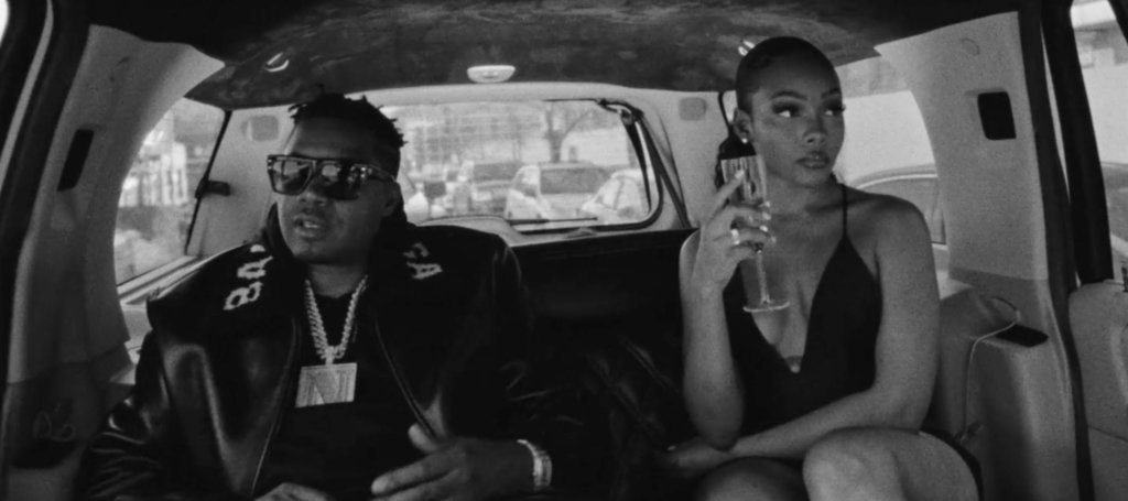 B&W Nas with woman in limo.