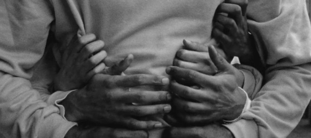 B&W Closeup 7 hands reaching around to hug someone