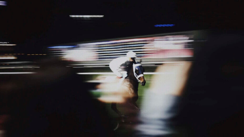 Jockey In A White Helmet Rides A Horse