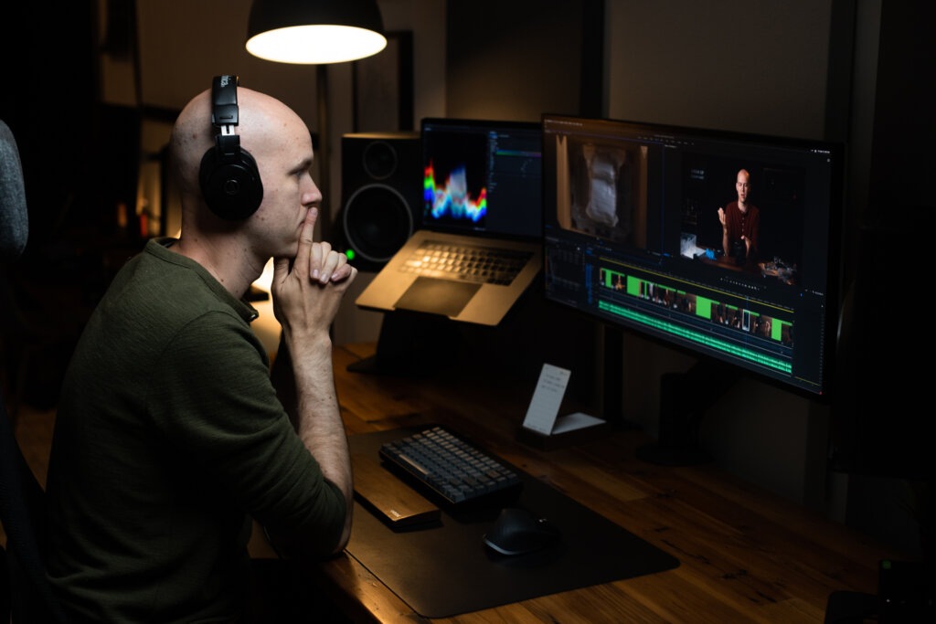 Caleb Wojcik editing video in studio