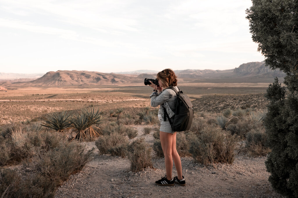 Kitty Peters taking photo in desert