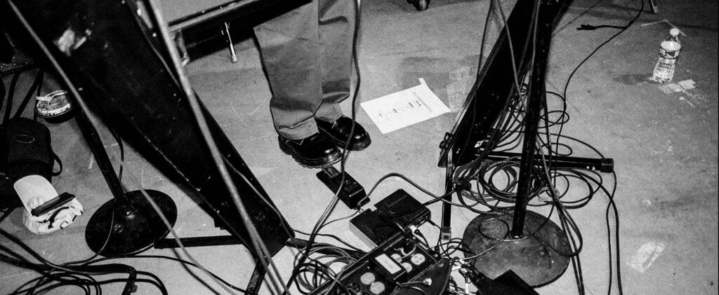 Person Standing at Keyboard And Sound Equipment