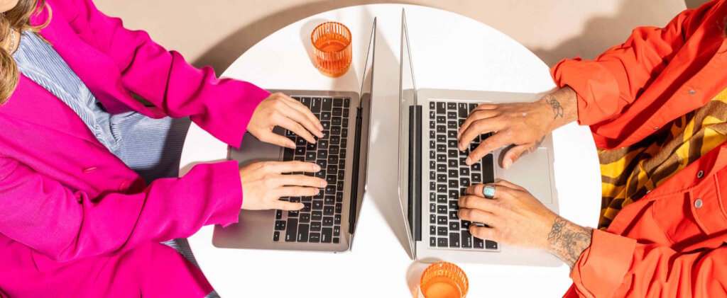 Two People Are Sitting At A Round White Table Facing Each Other 