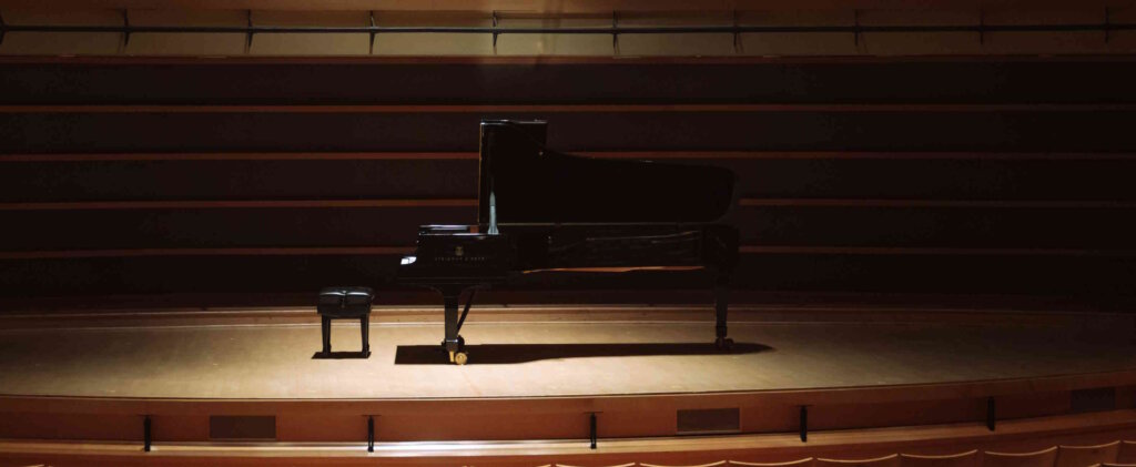 Piano on a slightly lit empty scene.