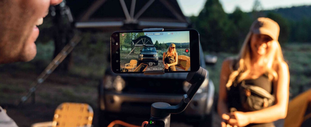 A Man Filming A Woman With A Smartphone