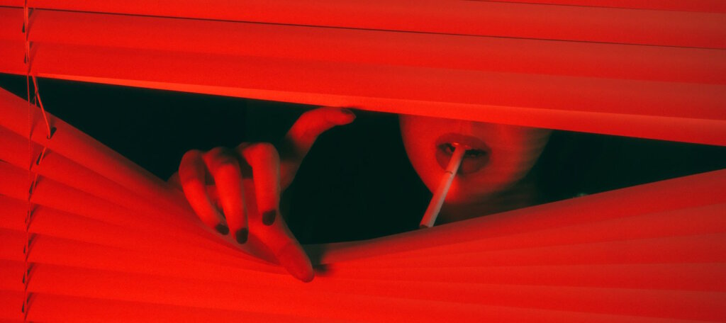 Color Choice in Storytelling - Woman with a cigarette looking out the window