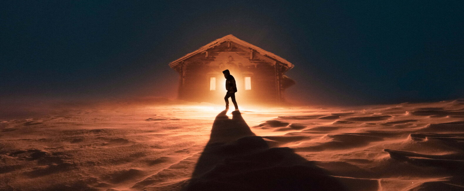 Silhouette Of A Person Walking In The Snow