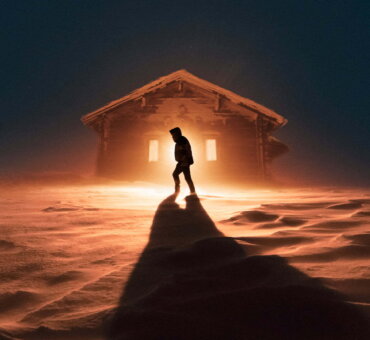 Silhouette Of A Person Walking In The Snow