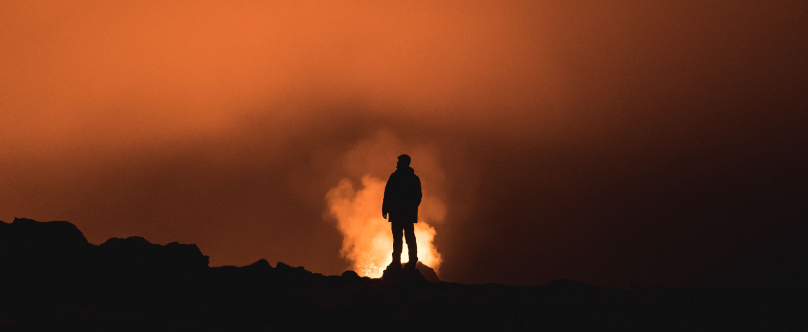 Exploring Visual Narratives - Man standing on a mountain at sunset