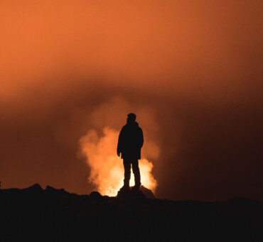 Exploring Visual Narratives - Man standing on a mountain at sunset