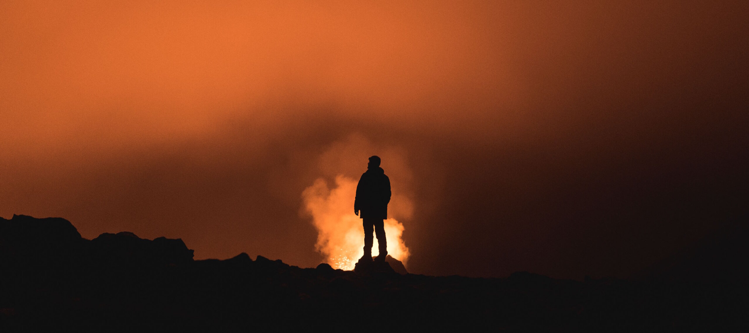 Exploring Visual Narratives - Man standing on a mountain at sunset