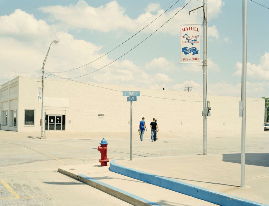 People walking in a street in bright daylight