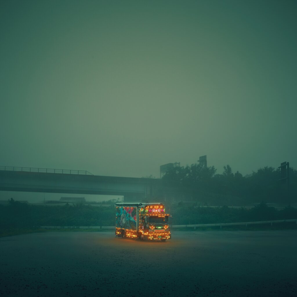 A Shipping Semi Truck Drives On A Road During A Foggy Day