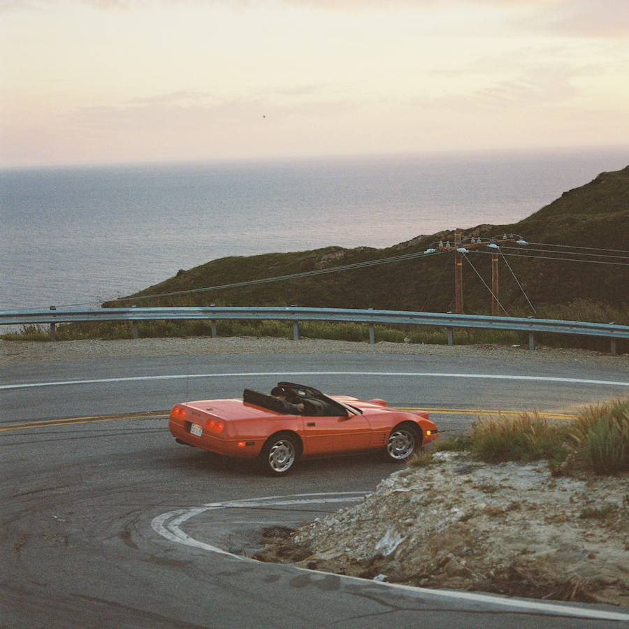 A Car Driving Down A Road