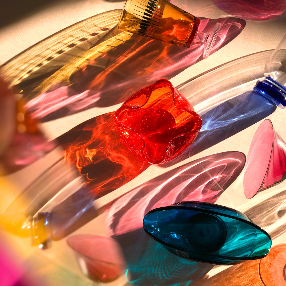 A Bright Light Shines On Various Pieces Of Bright Colored Glass