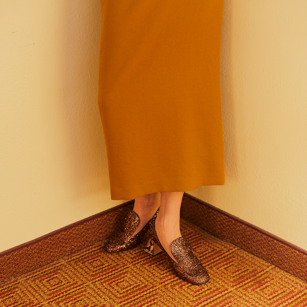 A View Of A Woman In A Dress With Shoes