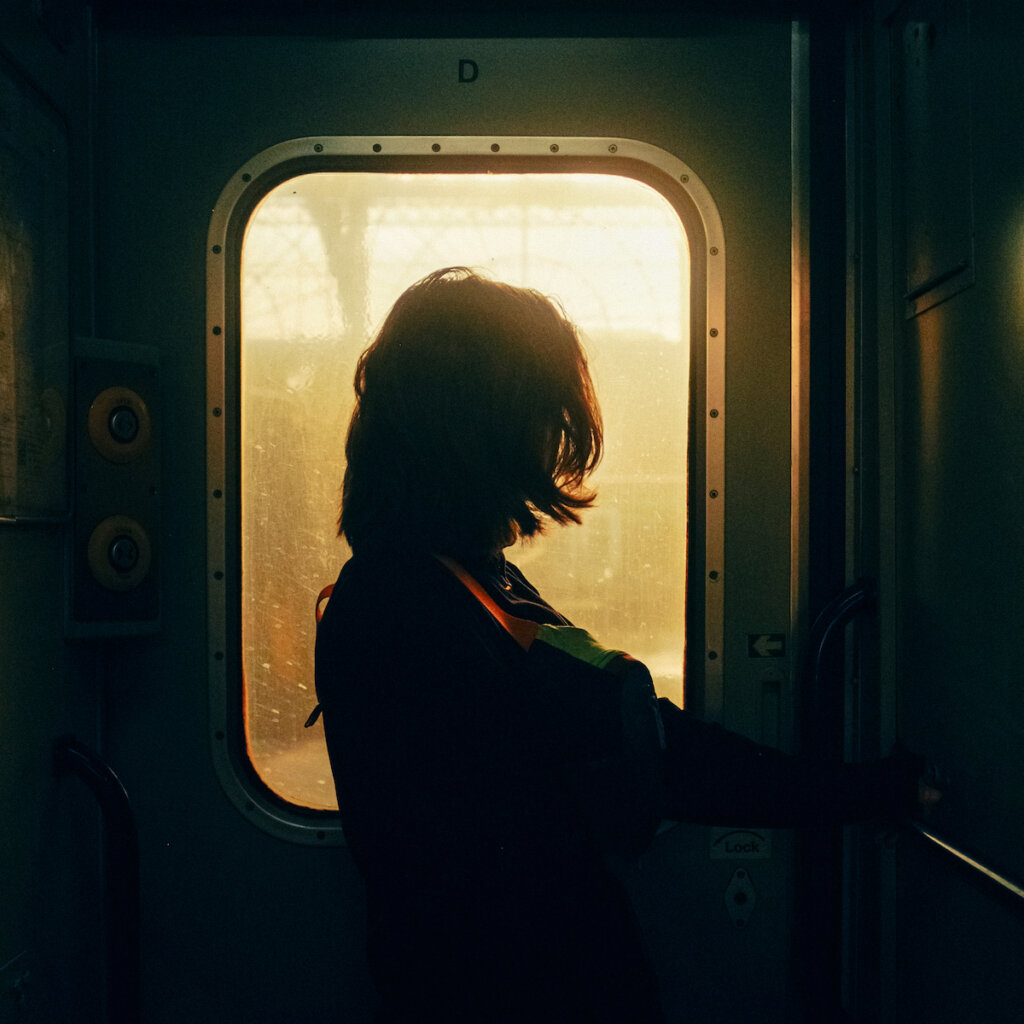 Woman Illuminated By A Soft Light That Enters Through A Train Window