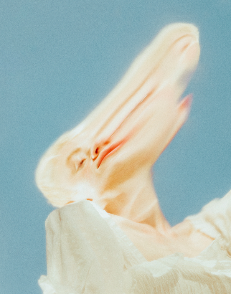 Close Up Of Stretched Face Of Model Wearing Fashionable Blouse